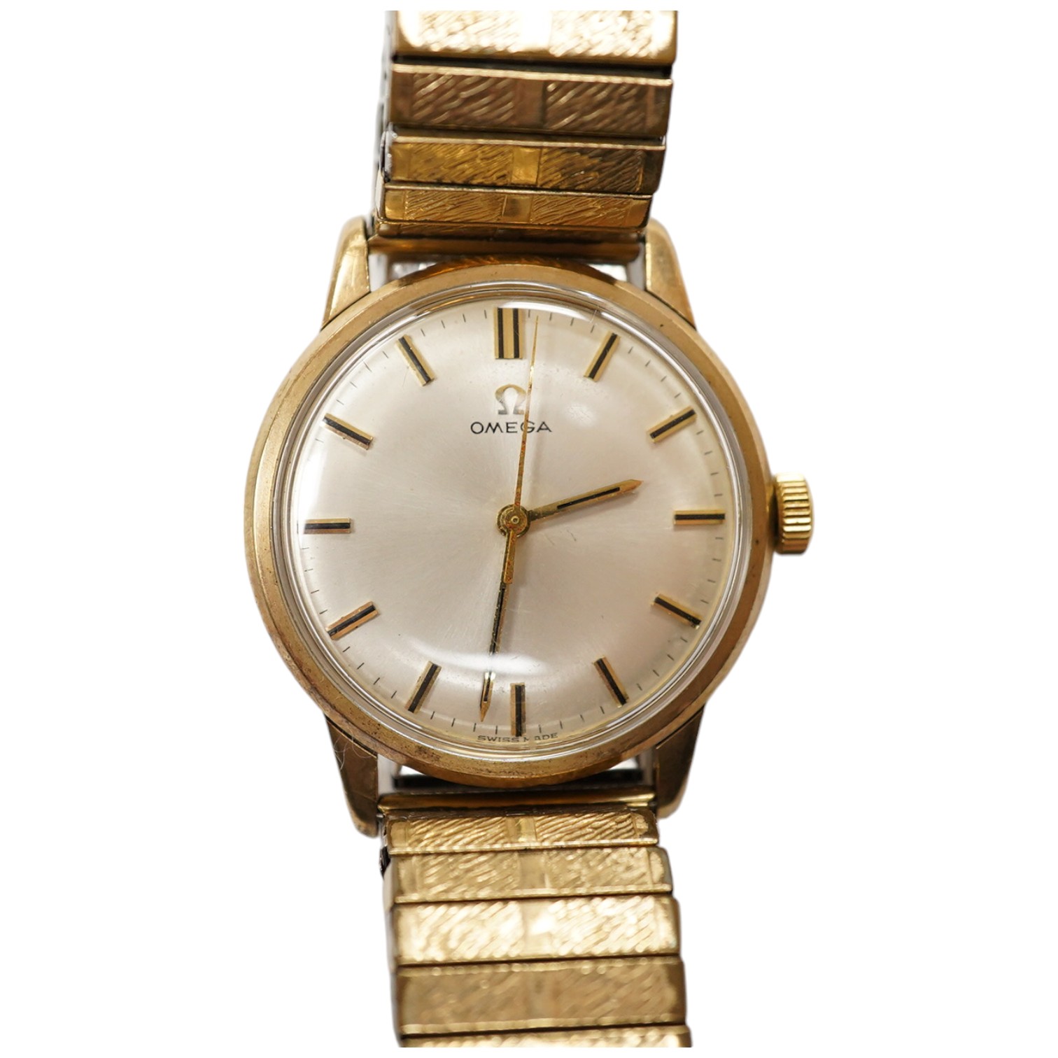 A gentleman's yellow metal Omega manual wind wrist watch, with baton numerals, case diameter 34mm, on an associated rolled gold flexible strap. Condition - fair